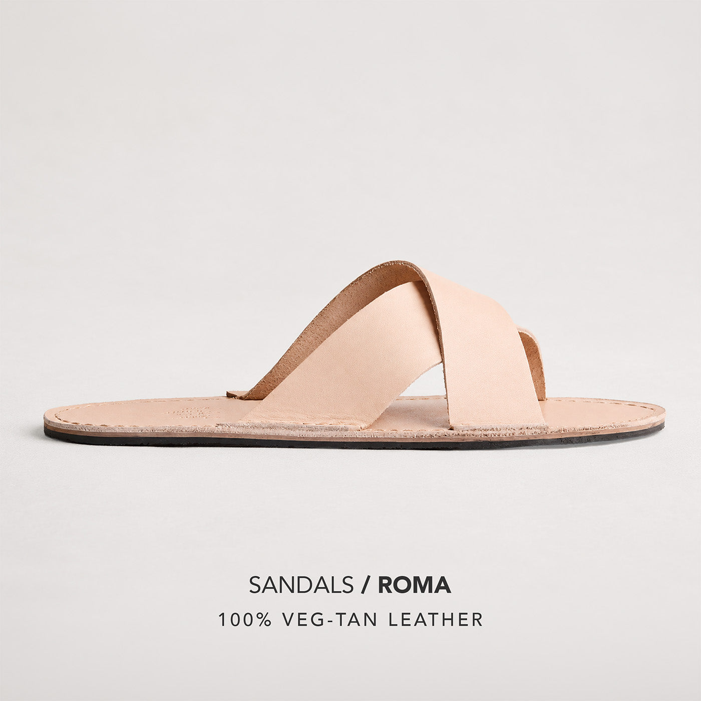Crema | Flat leather sandal with debossed PLG three tree logo in sole, text reads "Sandals Roma 100% Veg Tan Leather"