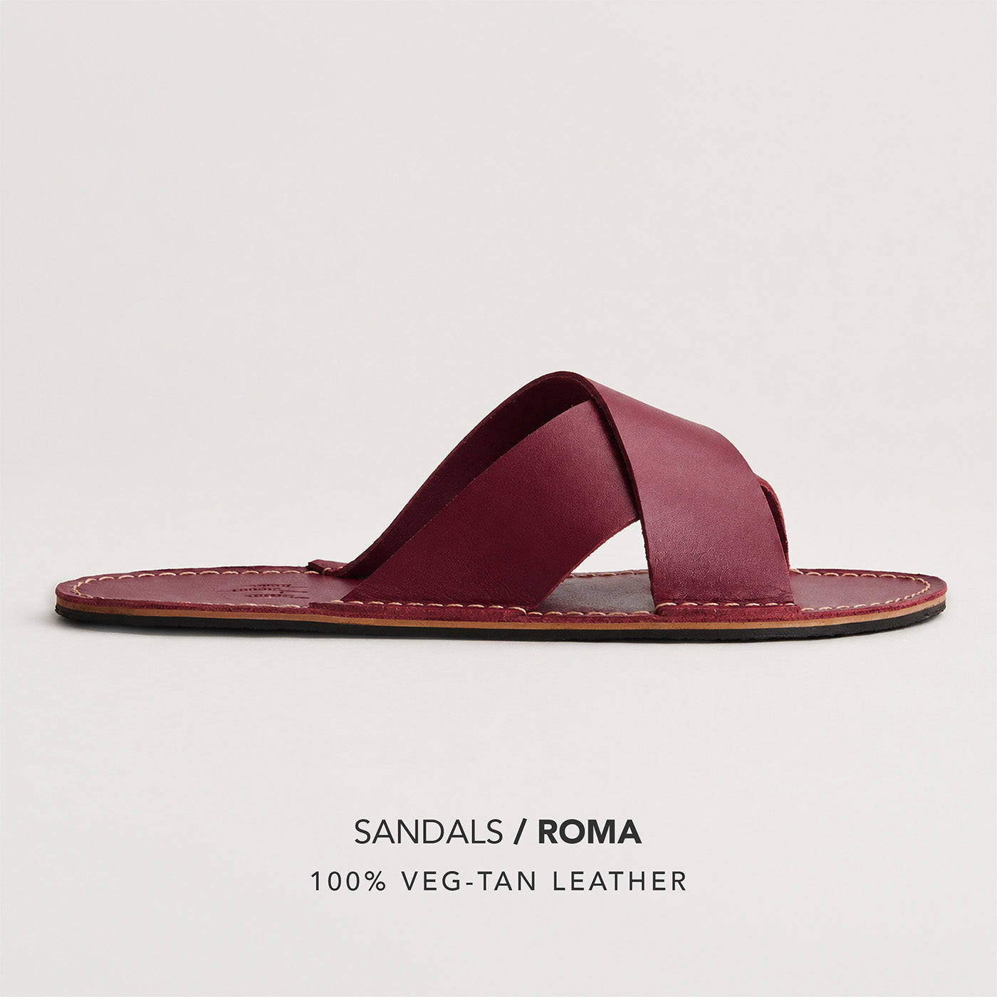 Marsala | Flat leather sandal with debossed PLG three tree logo in sole, text reads "Sandals Roma 100% Veg Tan Leather"