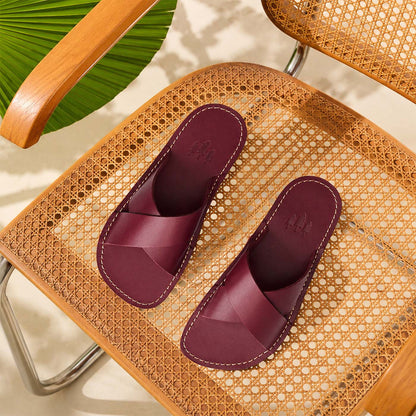 Marsala | Red wine colored-leather flat sandals with debossed Portland Leather trees logo set on a woven chair