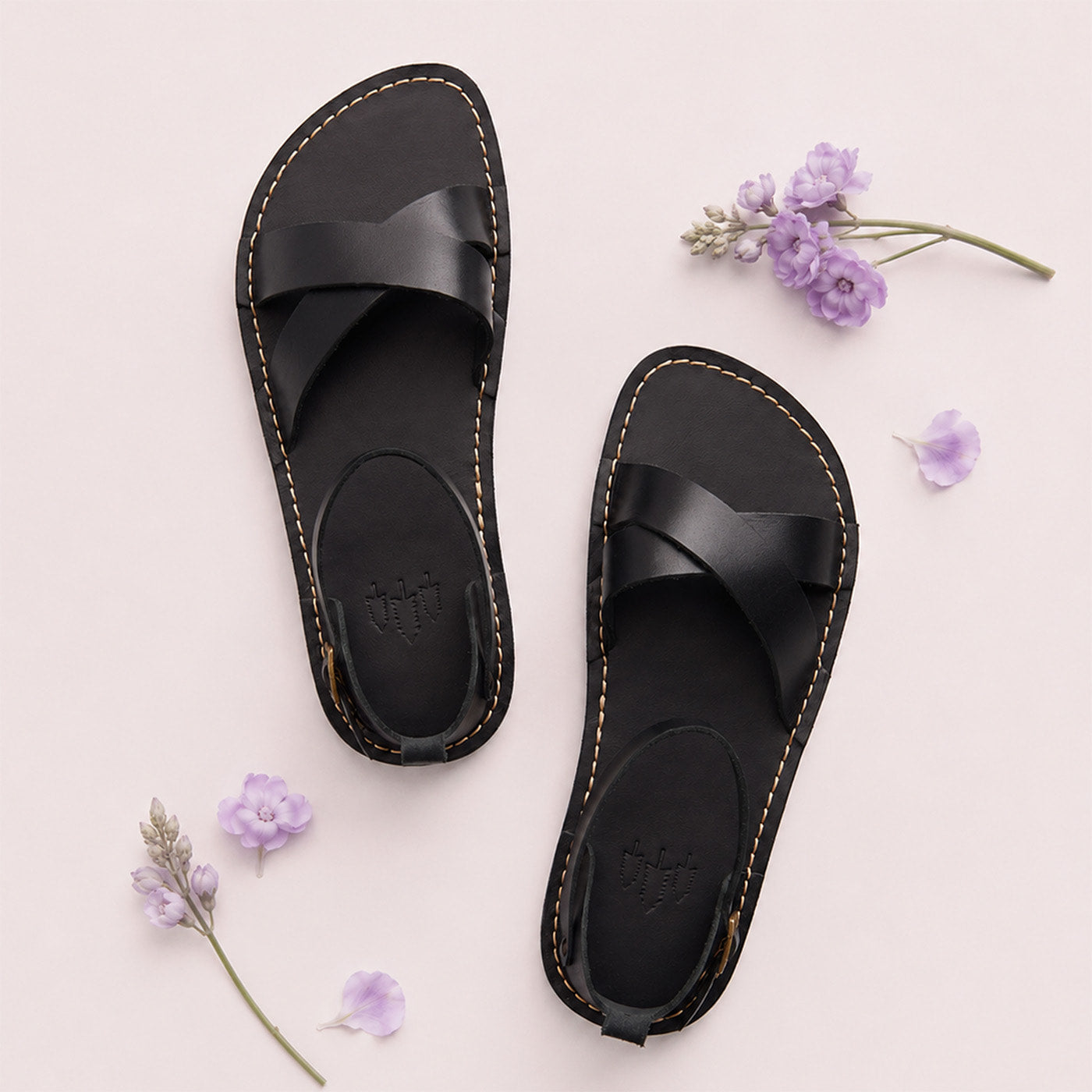 Nero | Flat leather sandals with ankle straps and debossed PLG three tree logo in soles