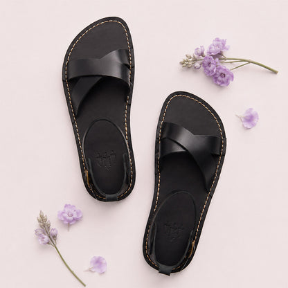 Nero | Flat leather sandals with ankle straps and debossed PLG three tree logo in soles