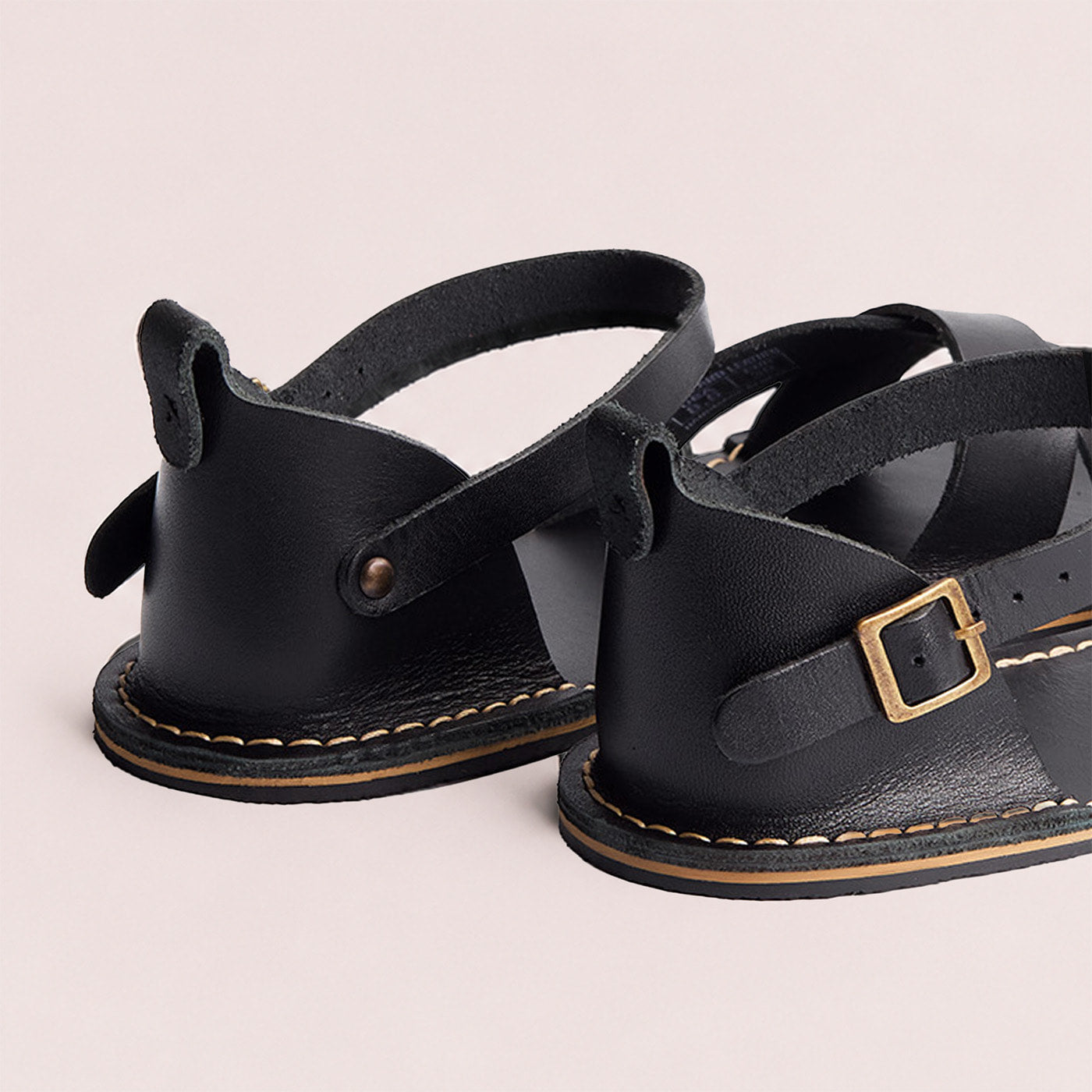 Nero | Flat leather sandals with ankle straps and debossed PLG three tree logo in soles