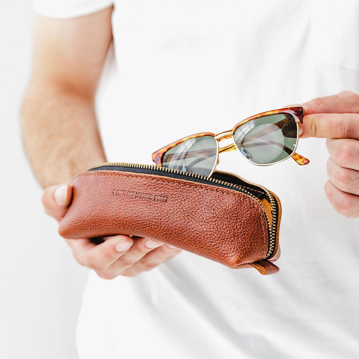 All Color: Nutmeg | Leather pouch with curved seams and top zipper