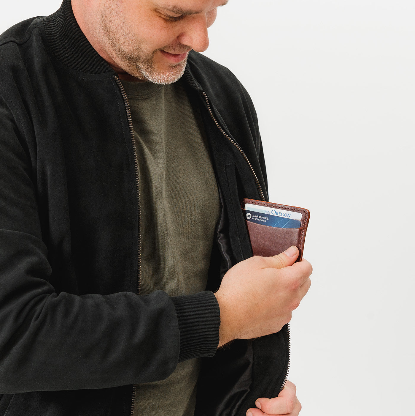 Cognac | Model hodling minimalist leather wallet with card slots