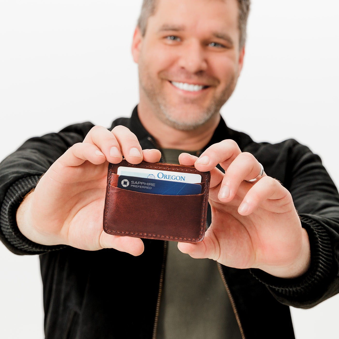 Cognac | Model hodling minimalist leather wallet with card slots