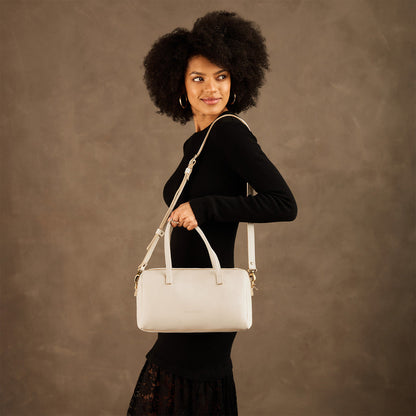 Pebbled Bone*Oversized | Model holding mini duffle shaped handbag with crossbody strap