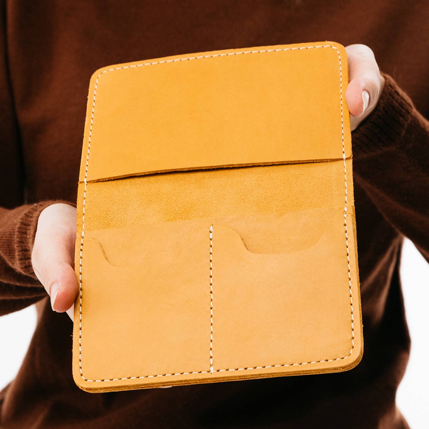 Sunflower | Model holding leather passport case with PLG logo