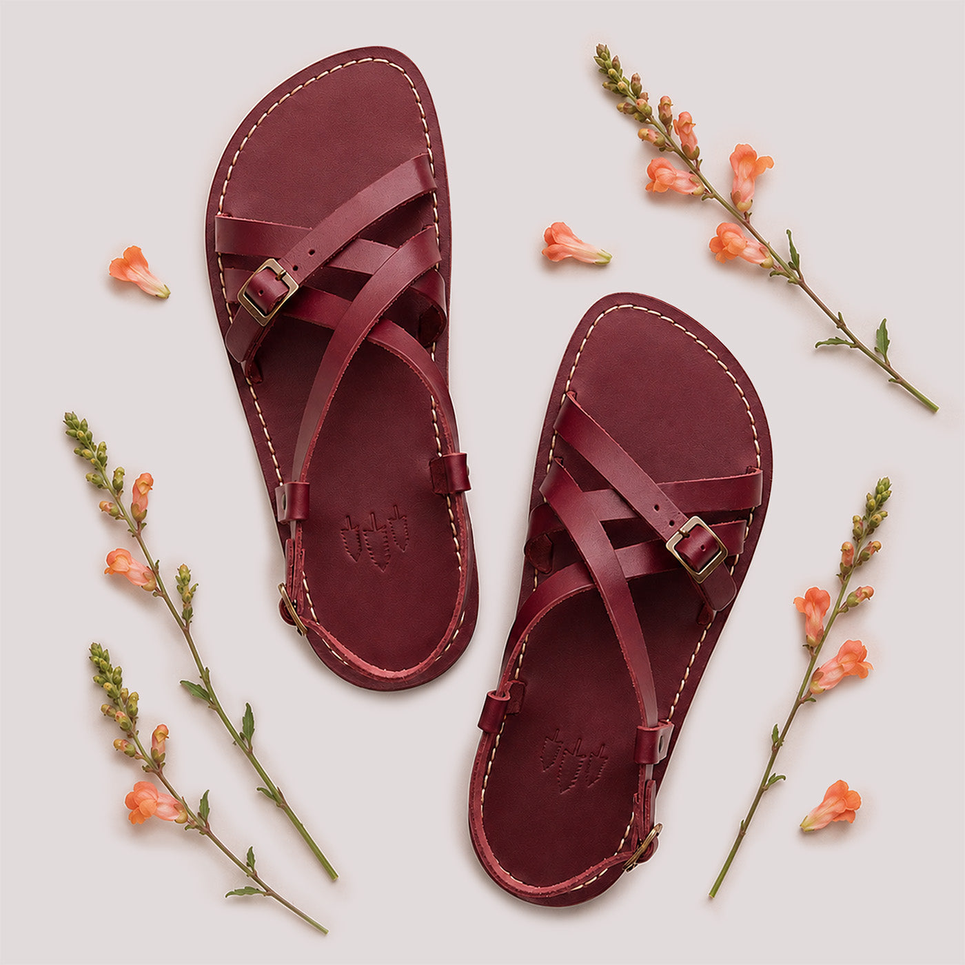Marsala | Person wearing strappy leather sandals with two buckle accents