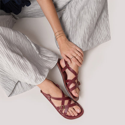 Marsala | Person wearing strappy leather sandals with two buckle accents
