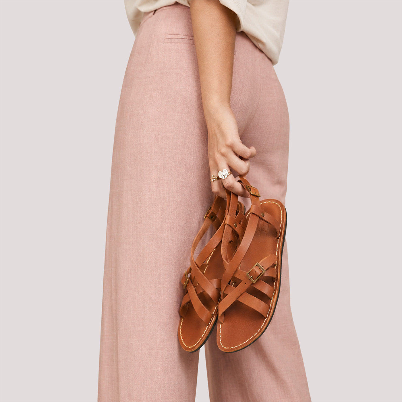 Miele | Person wearing strappy leather sandals with two buckle accents