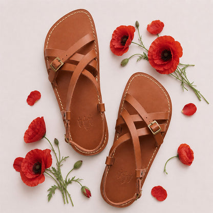 Miele | Person wearing strappy leather sandals with two buckle accents