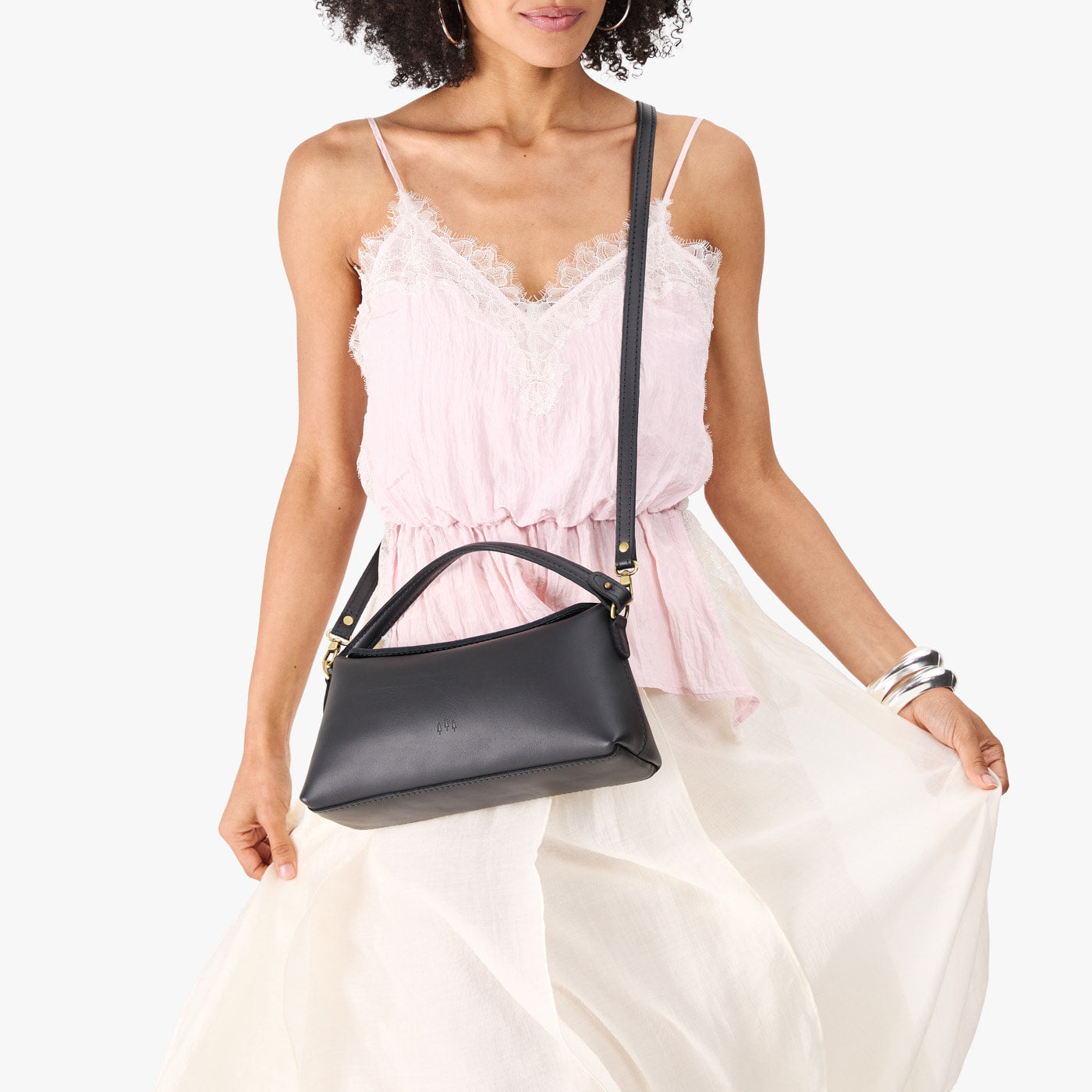 Black | Model holding a black colored bowler style hand bag