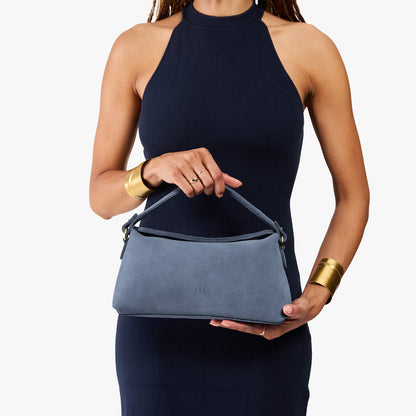 Denim | Model holding a light blue bowler style hand bag