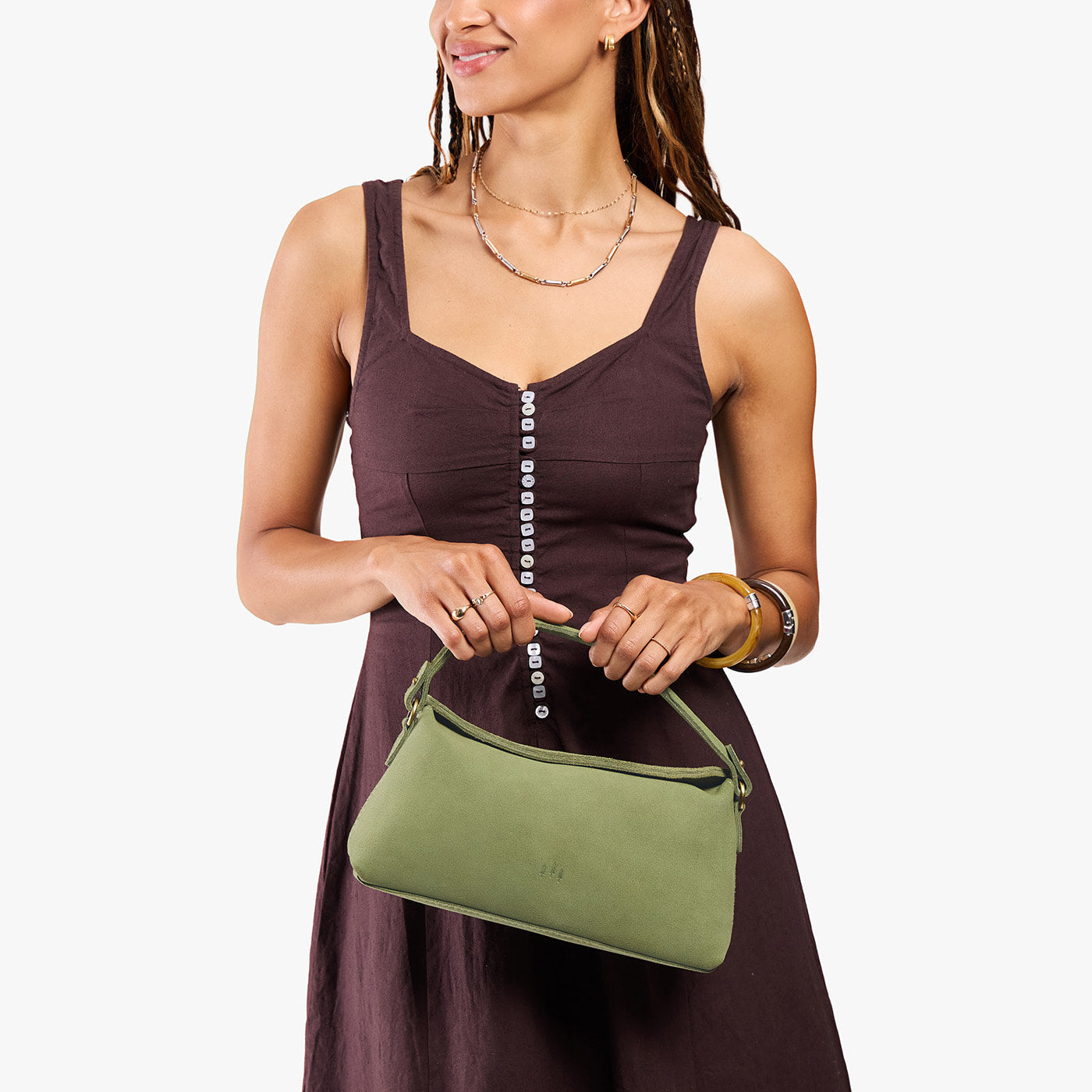 Laurel | Model holding a light green bowler style hand bag