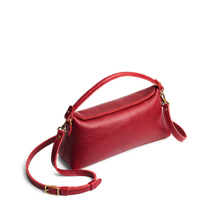 Chili Red | Leather bowler bag with magnetic closure against a white background