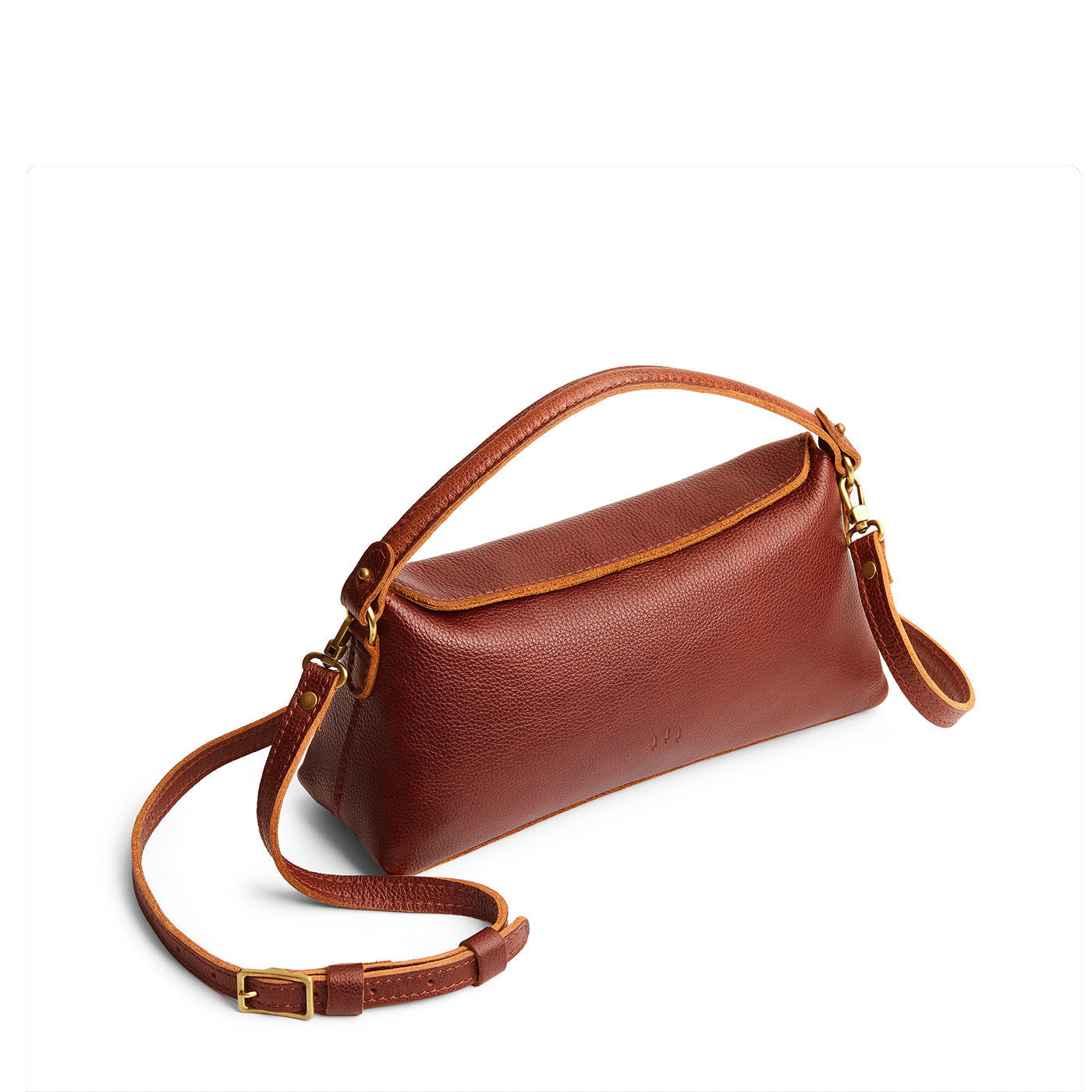 Nutmeg | Leather bowler bag with magnetic closure against a white background