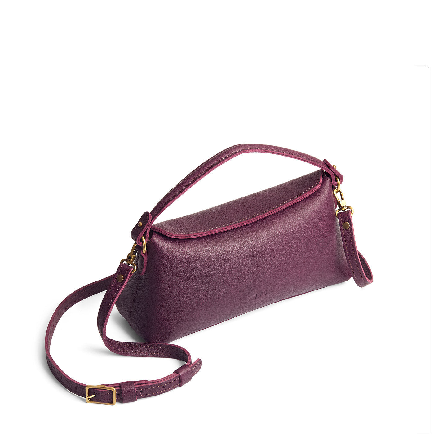 Plum | Leather bowler bag with magnetic closure against a white background