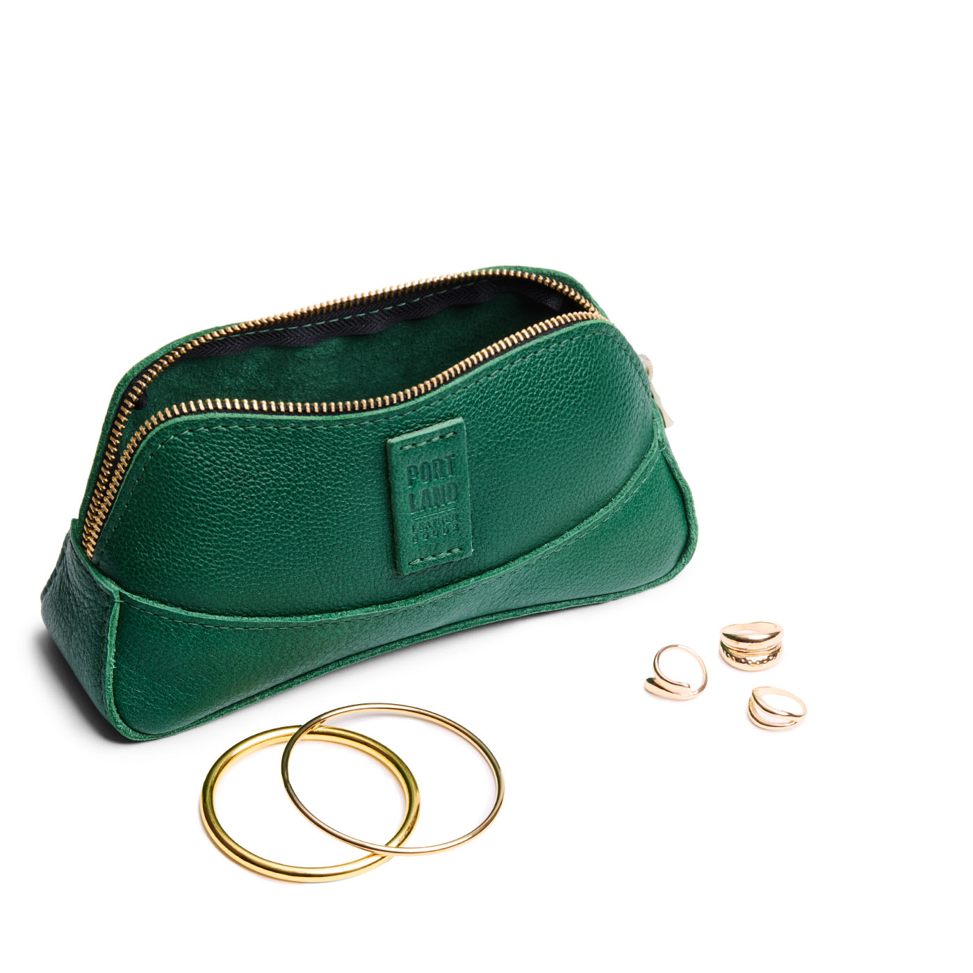 Bacalar | Handmade leather makeup bag pouch with top zipper open next to gold jewelry