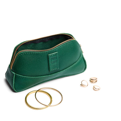 Bacalar | Handmade leather makeup bag pouch with top zipper open next to gold jewelry