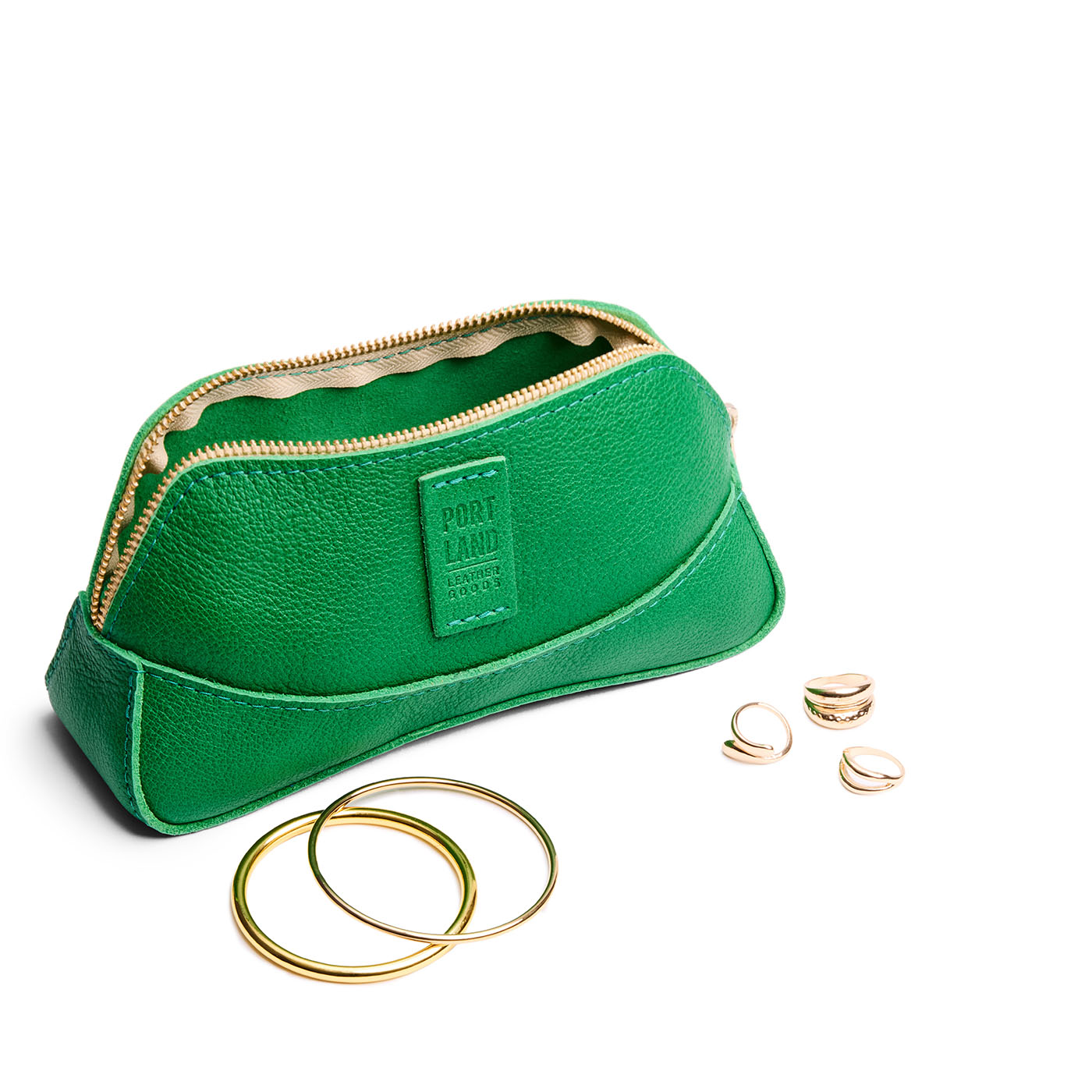 Jolly Green | Handmade leather makeup bag pouch with top zipper open next to gold jewelry