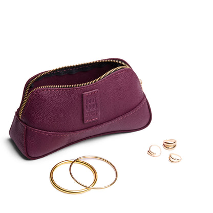 Potion | Handmade leather makeup bag pouch with top zipper open next to gold jewelry