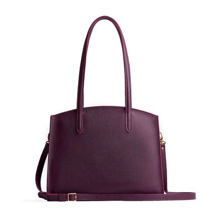 Plum*Large | Leather tote bag with handles, adjustable crossbody strap, zipper top, and two back pockets