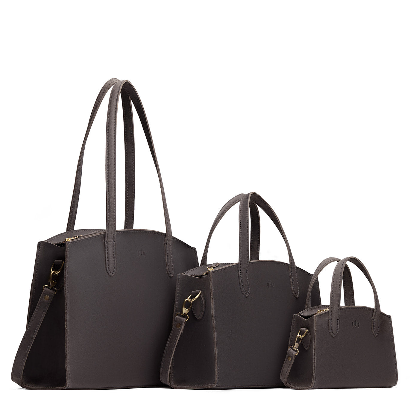 Full Moon | Size comparison image of Mini, Medium, and Large-sized leather tote bags with handles, adjustable crossbody strap, zipper top, and back pockets