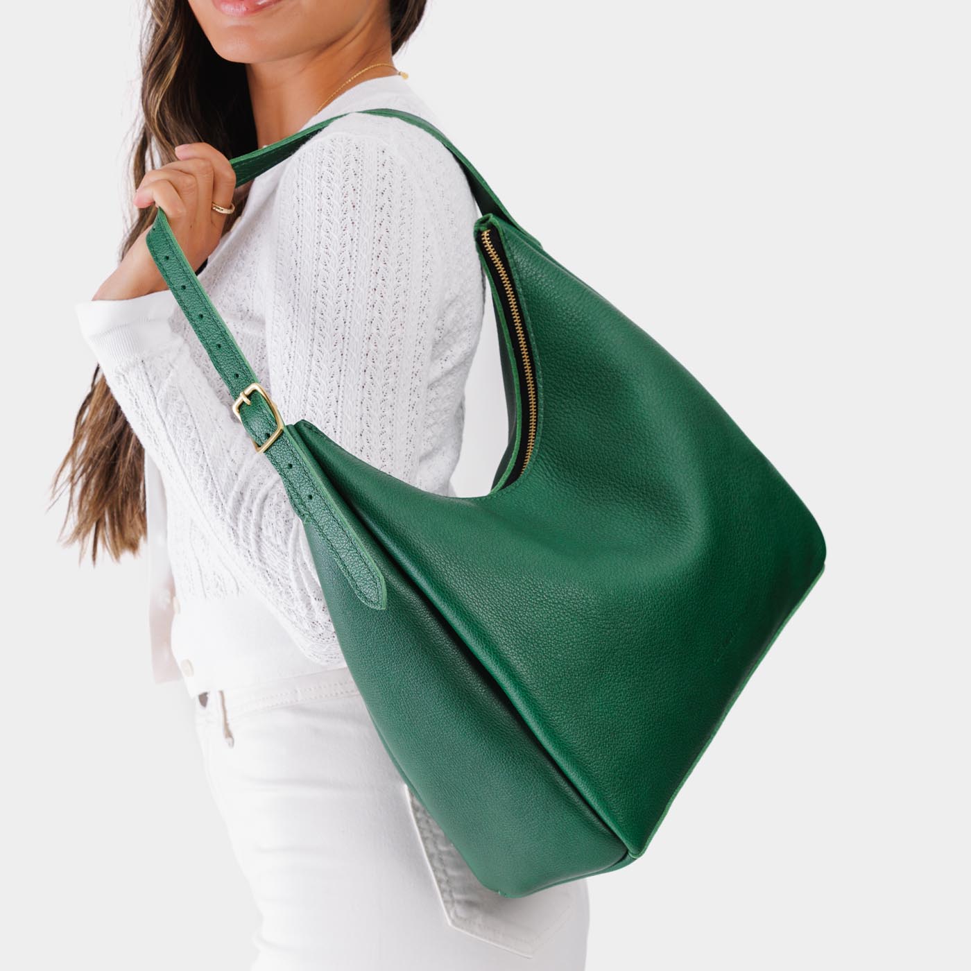 Bacalar*Large | Model holding u-shaped, flat-bottomed leather shoulder bag with adjustable strap