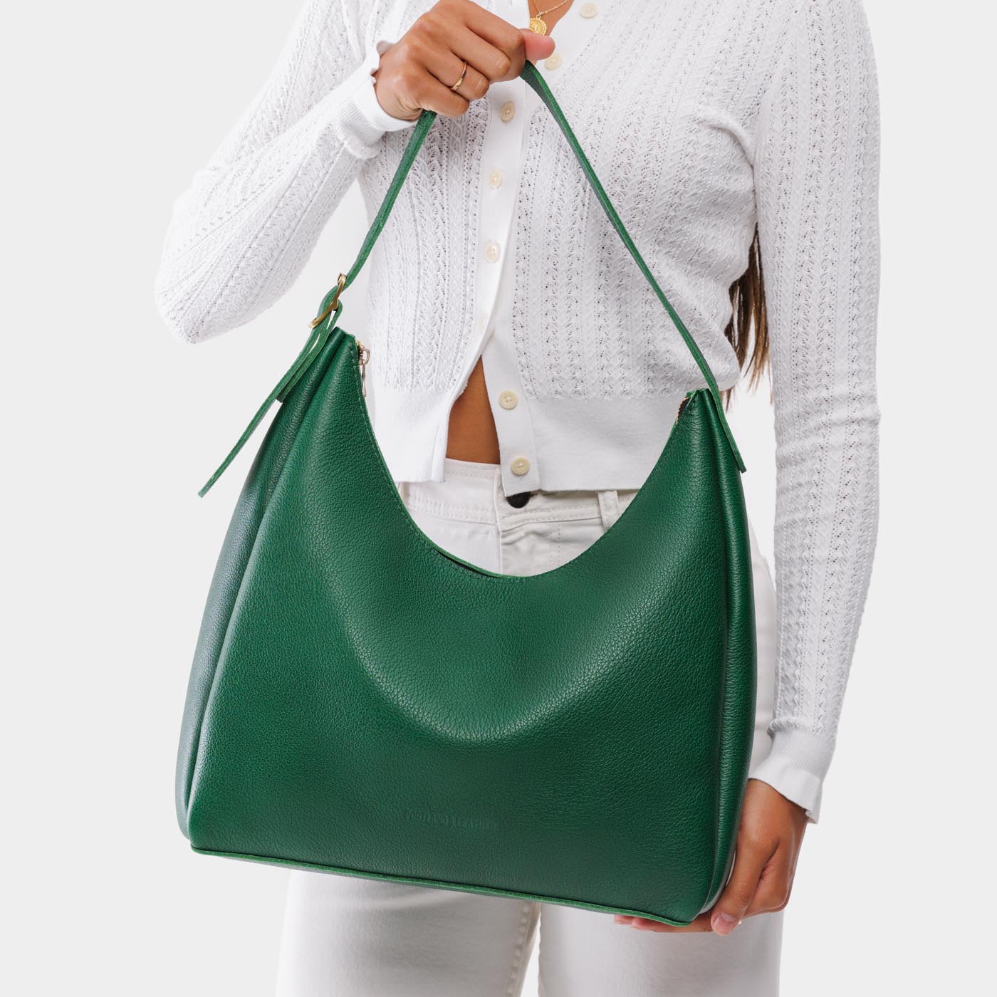Bacalar*Large | Model holding u-shaped, flat-bottomed leather shoulder bag with adjustable strap