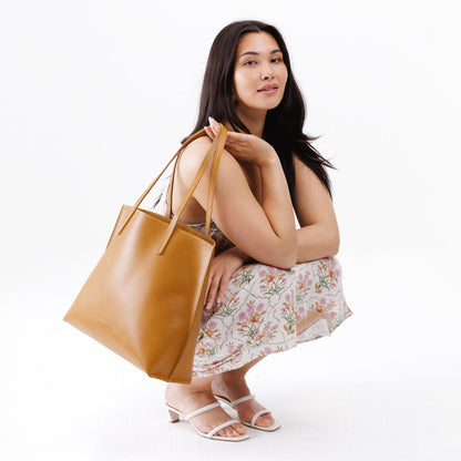 Mango*Large | Model holding leather tote bag with interior snap key loop