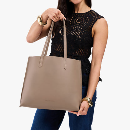 Stone*Large | Model holding leather tote bag with matching leather handles