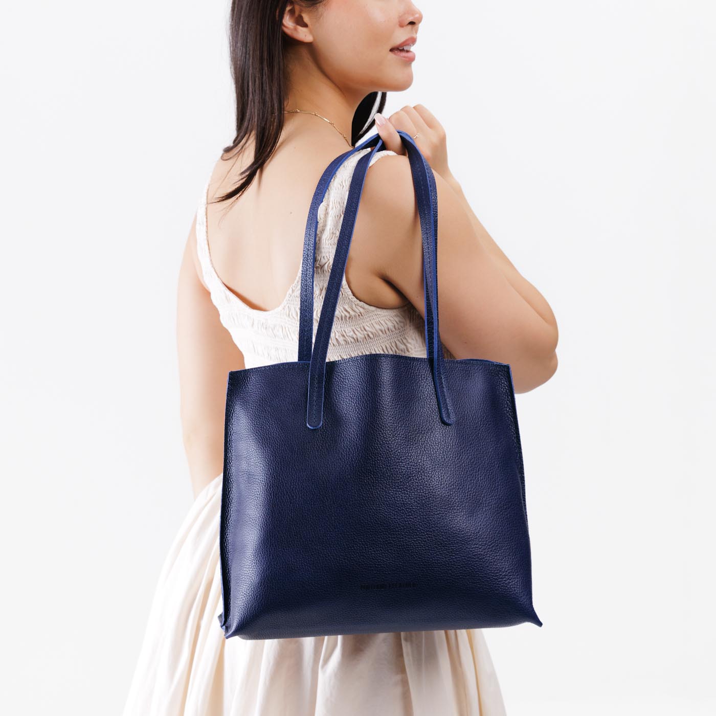 Cobalt*Medium | Model holding leather tote bag with interior snap key loop