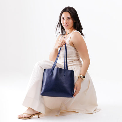 All Variants | Model holding a Medium Cobalt August Tote