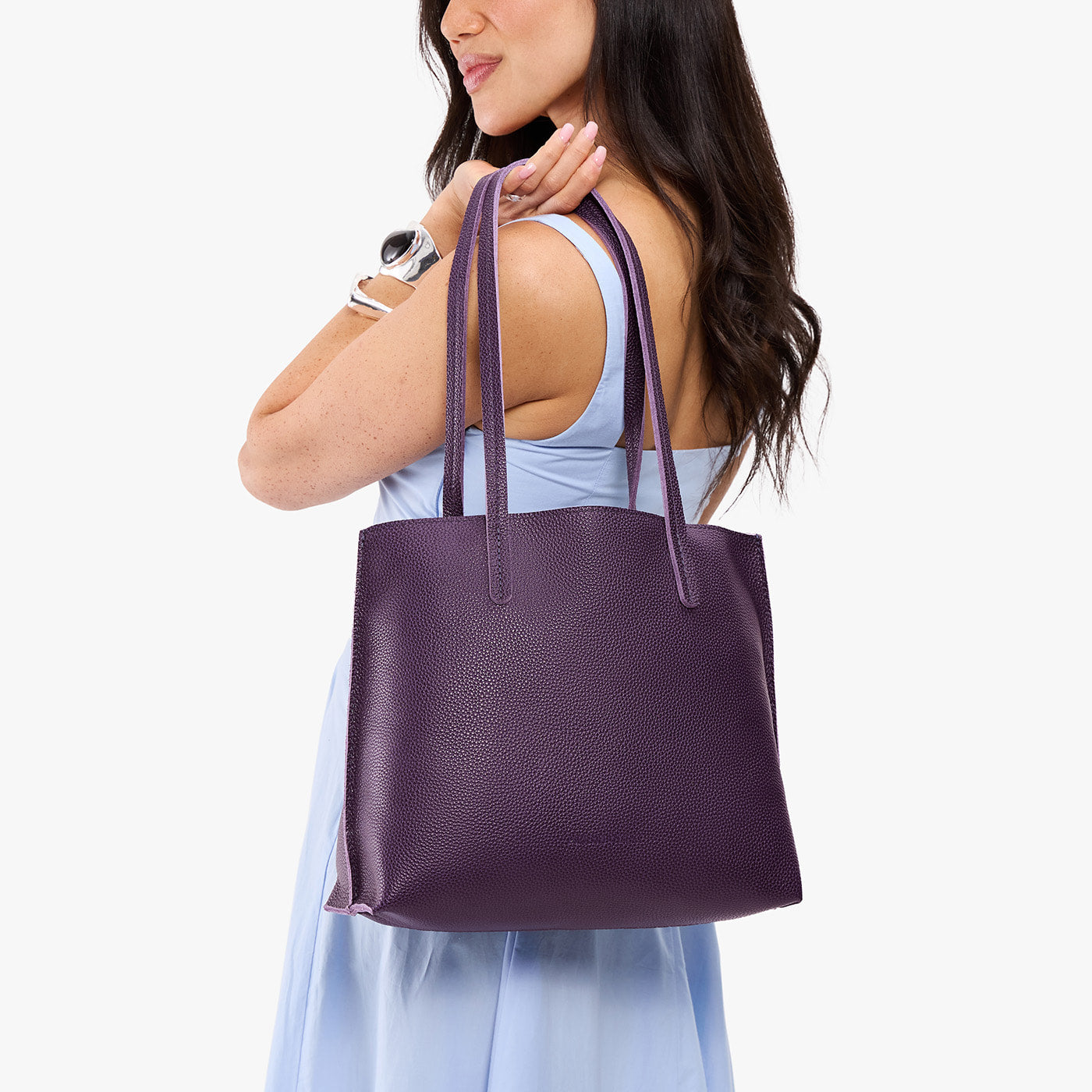 Empire*Medium | Model holding leather tote bag with matching leather handles