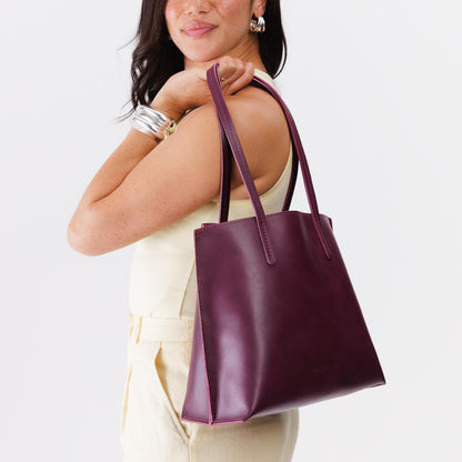 Lollipop*Medium | Model holding leather tote bag with interior snap key loop