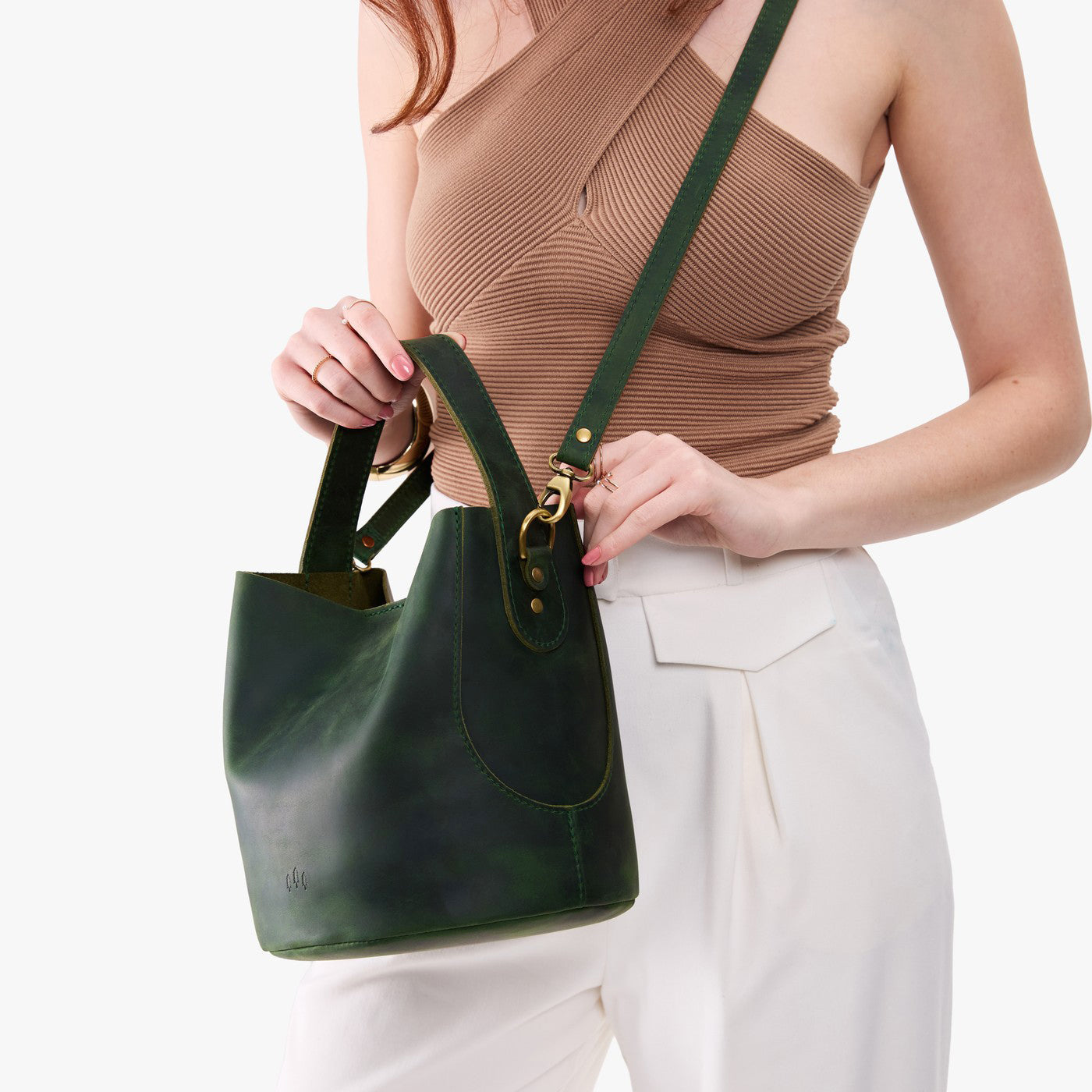 Evergreen*Large | Model holding symmetrical bucket bag with handle, latch closure, and removable crossbody strap