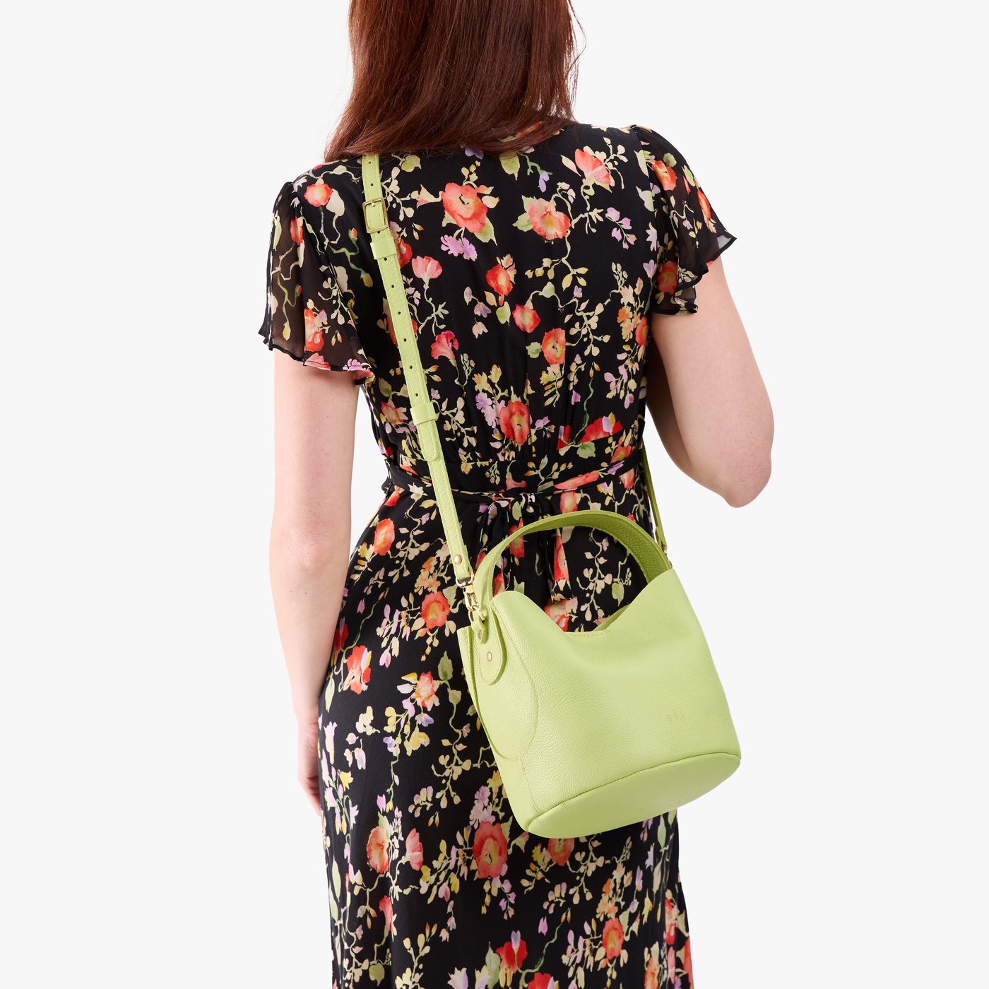 Shadow Lime*Small | Model wearing symmetrical bucket bag with handle, latch closure, and removable crossbody strap