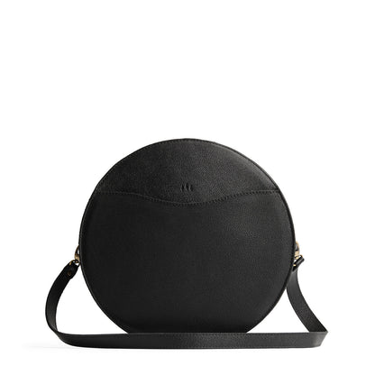Pebbled--black | Large circle shaped leather bag with top zipper and carrying strap