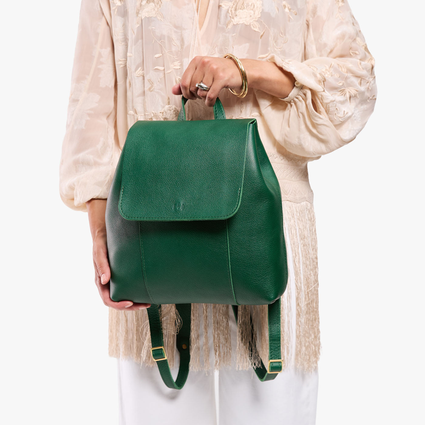 Bacalar | Model holding a leather backpack on a white background