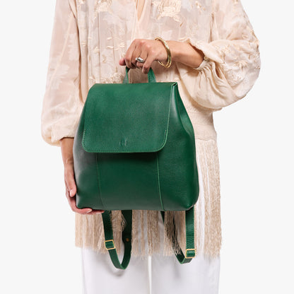 Bacalar | Model holding a leather backpack on a white background