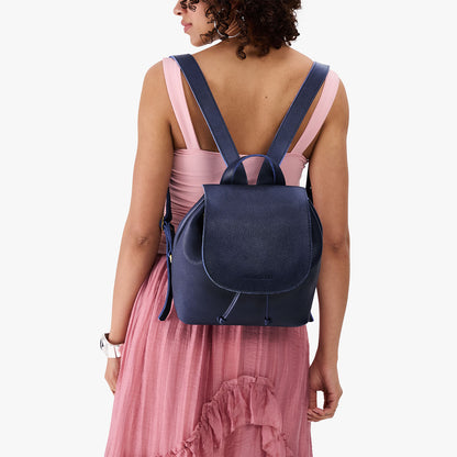 Cobalt | Pebbled leather drawstring backpack being worn by a person