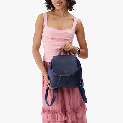 Cobalt | Pebbled leather drawstring backpack being worn by a person