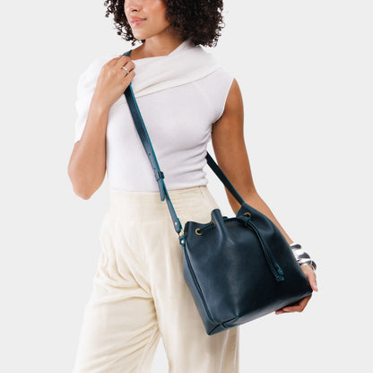 Boreal*Large | Model holding slouchy crossbody bag with drawstring closure