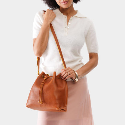 Sienna*Large | Model holding slouchy crossbody bag with drawstring closure