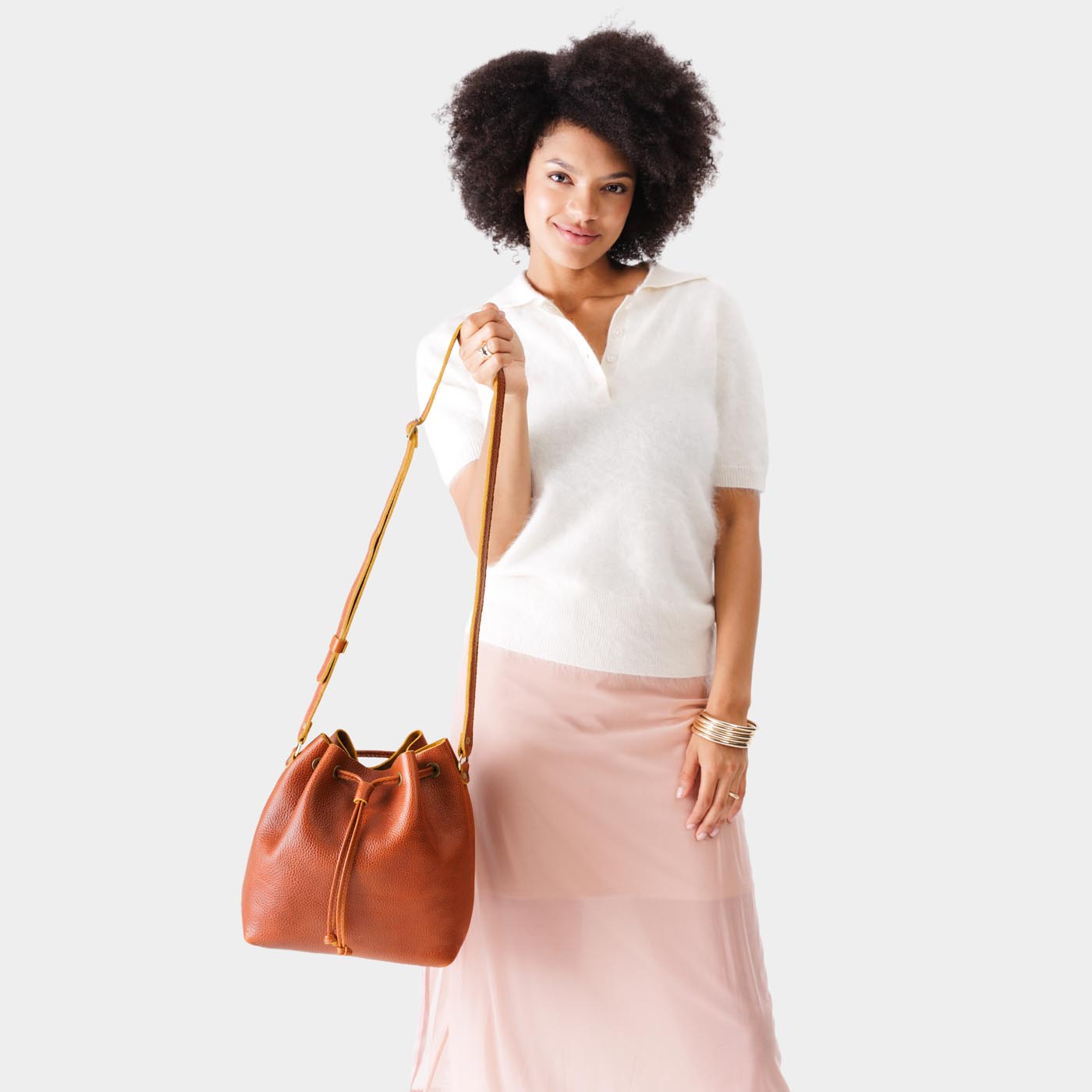 Sienna*Large | Model holding slouchy crossbody bag with drawstring closure