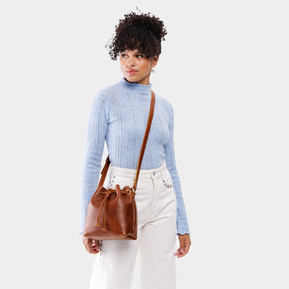 Nutmeg*Small | Model wearing slouchy crossbody bag with drawstring closure