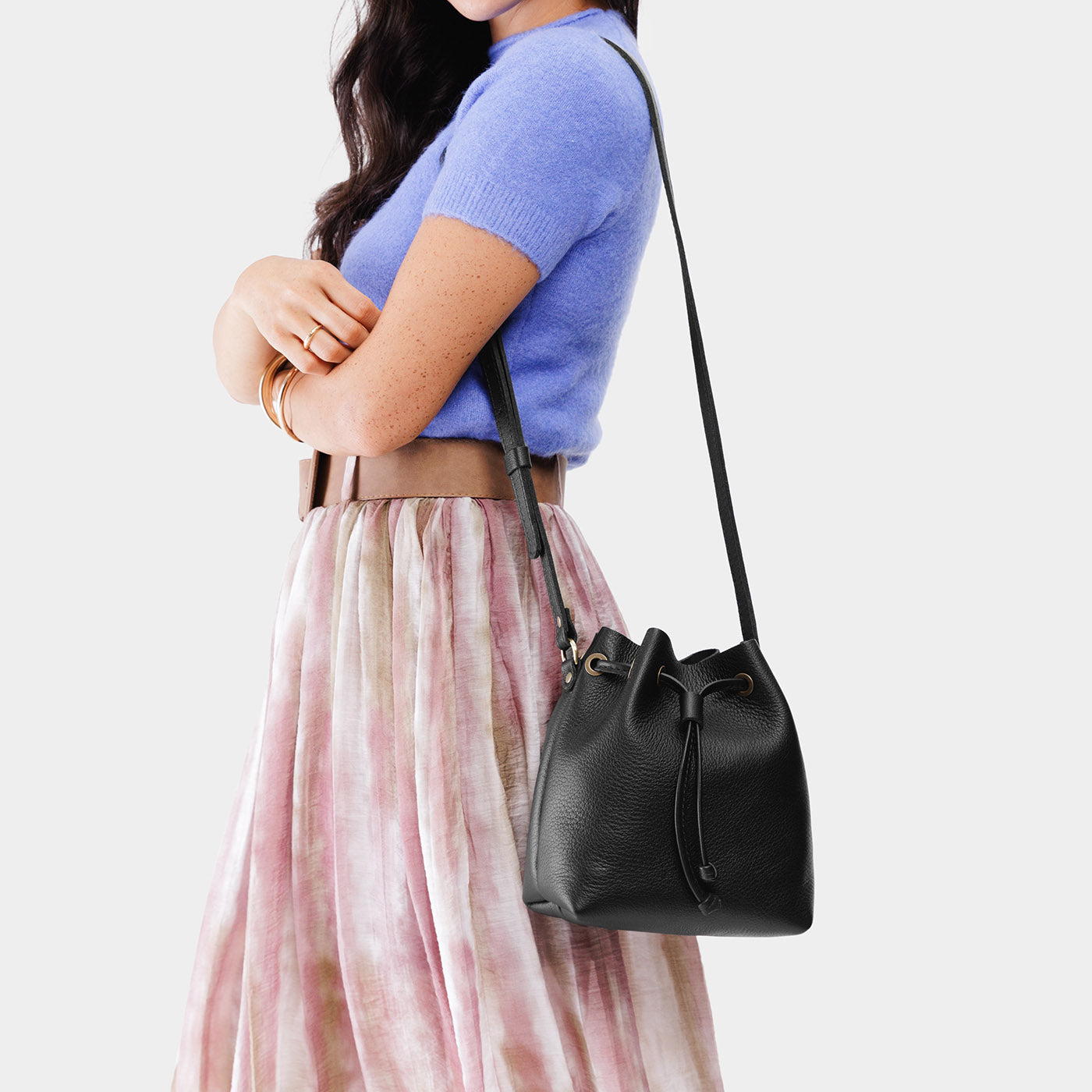 Pebbled--black*Small | Model wearing slouchy crossbody bag with drawstring closure