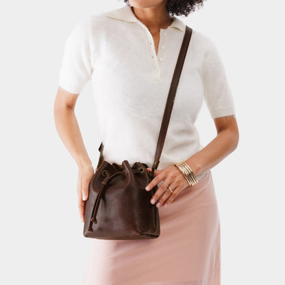 Coldbrew*Small | Model holding slouchy crossbody bag with drawstring closure