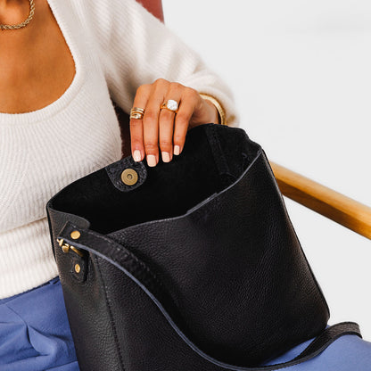 Pebbled--black | symmetrical bucket bag with latch closure and removable crossbody strap