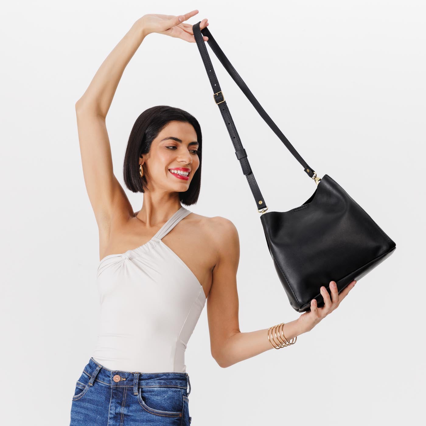 Black | symmetrical bucket bag with latch closure and removable crossbody strap
